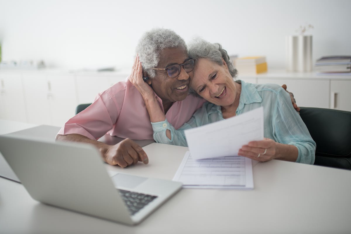 Senior couple reviewing retirement account statements together at a desk