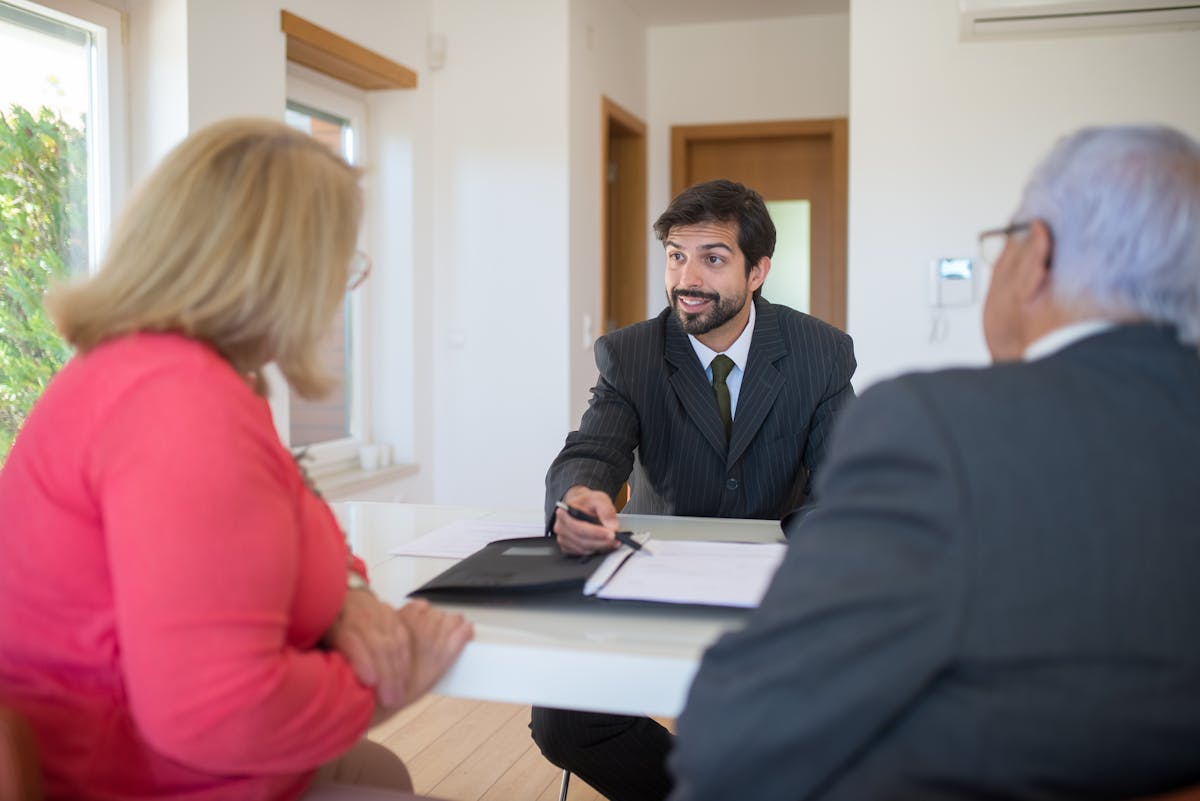 Couple meeting with advisor to sign direct transfer paperwork